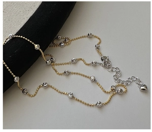 Detail of S925 silver two-tone beaded necklace with heart pendant and lobster clasp