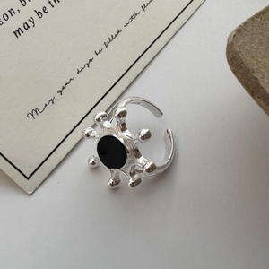 S925 sterling silver sunburst ring with black agate inlay shown in a lifestyle setting