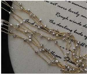 Detail of S925 silver beaded necklace with mixed gold and silver cylindrical accents