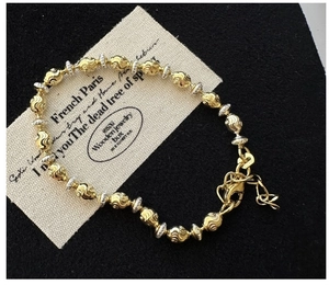 Detail of S925 silver mixed-metal beaded bracelet featuring spiral texture and lobster clasp