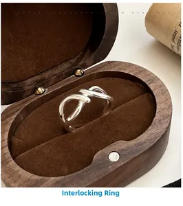 Detail view of silver S925 cross texture ring displayed in a vintage jewelry gift box