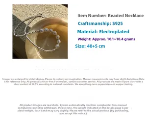 Detailed close-up of 925 sterling silver beaded necklace with textured center bead detail