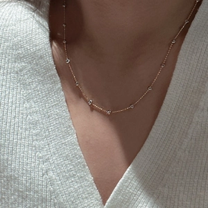 Elegant gold S925 sterling silver necklace with sparkling round zircon gems worn on neck