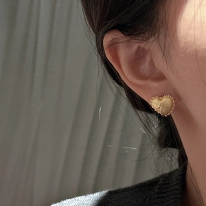 Elegant vintage gold heart earrings with brushed metal texture and floral detail