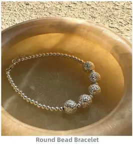 Macro view of S925 sterling silver beaded bracelet with hammered texture on stone tray