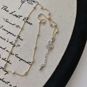 Minimalist S925 sterling silver two-tone beaded necklace with heart pendant and cat-eye detail