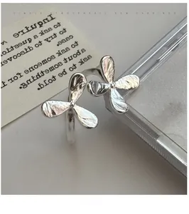 Detail showing hand-hammered texture on S925 silver flower ring with adjustable band
