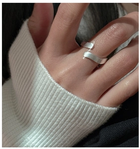 Close-up of S925 sterling silver wave ring with brushed matte texture on model hand