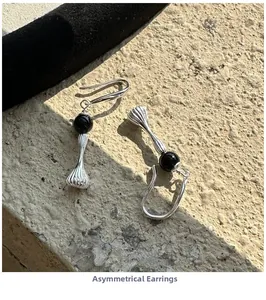 Detailed view of handmade S925 silver irregular earrings with retro black sphere accents