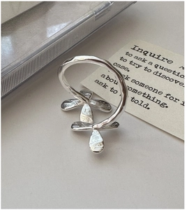 Macro detail of S925 sterling silver ring with hand-hammered texture and floral motifs