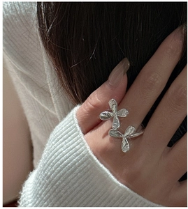 Close-up of S925 silver ring featuring handcrafted floral texture on model hand