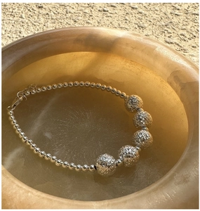 Macro shot of S925 sterling silver beaded bracelet with hammered texture beads