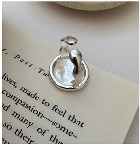 Artistic S925 sterling silver hug ring with abstract design on an open book page
