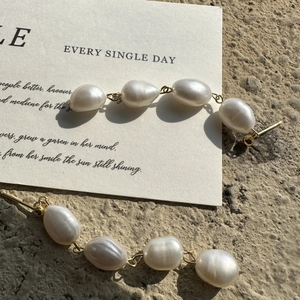 Baroque freshwater pearl necklace with gold OT clasp on a minimalist display card