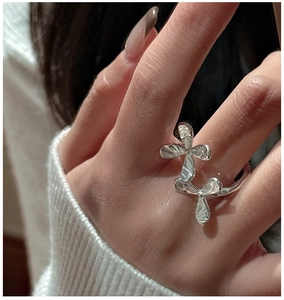 Close-up of S925 sterling silver open ring with irregular floral texture on a model's finger
