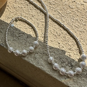 Minimalist S925 sterling silver bead jewelry set featuring a necklace and heart charm bracelet
