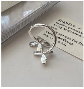 Macro detail of S925 silver ring featuring delicate floral patterns and hammered texture
