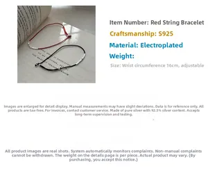 Detail of adjustable red and black string bracelets with S925 silver beads on a book