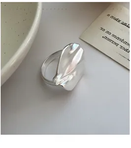 Macro shot of minimalist S925 sterling silver ring with organic crinkled metal texture