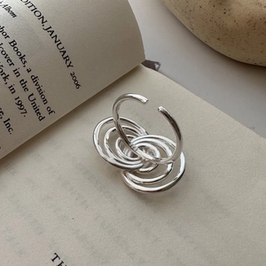 S925 sterling silver multi-layered wrap ring with minimalist aesthetic on a book