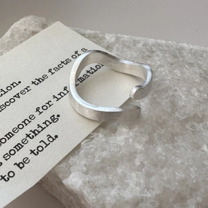 Minimalist S925 sterling silver open ring with brushed texture on a white crystal stone