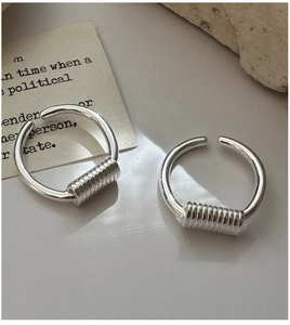 Detail of minimalist S925 silver open rings featuring unique spring-like wire wrap texture