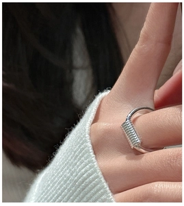 Macro shot of minimalist S925 sterling silver ring with twisted coil design detail