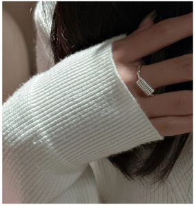 Detail of S925 sterling silver ring with unique spiral spring design on a finger