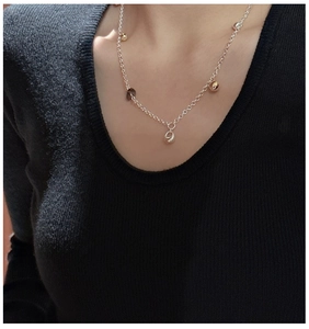 Detail view of a minimalist S925 silver necklace with geometric tea crystal pendants