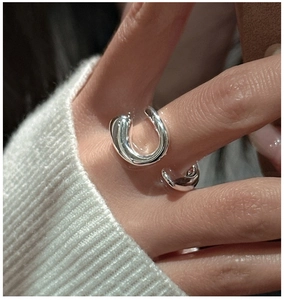 Macro shot of polished S925 sterling silver ring with irregular minimalist open design