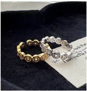 Macro detail of S925 silver coin rings with micro-set zircon in gold and silver finish