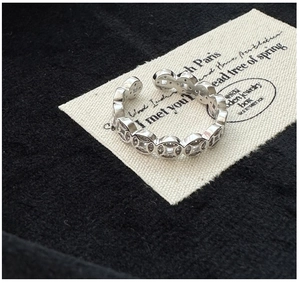 Macro detail of S925 silver ring featuring hollow coin links set with sparkling zircon