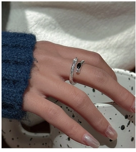 Detailed view of S925 sterling silver snake ring with black gemstone on middle finger