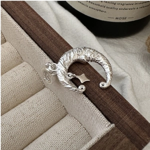 Detailed view of S925 sterling silver moon and star pendant with vintage wrinkled texture