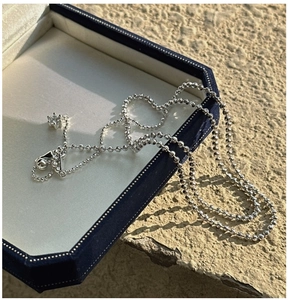 Detailed view of S925 silver beaded necklace with hexagonal star zircon pendant on velvet