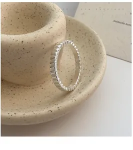 Macro shot of S925 sterling silver ring with vertical gear texture and inner hallmark