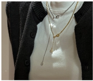 Detail of S925 sterling silver Y-shaped layered necklaces in gold and silver finishes