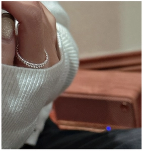 Close-up of S925 sterling silver ring with twisted rope texture worn on a finger