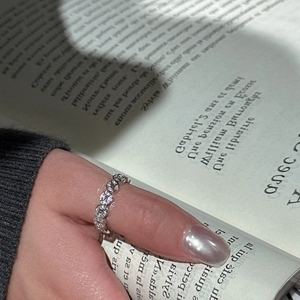 Minimalist S925 sterling silver ring featuring hollow coin design worn on thumb