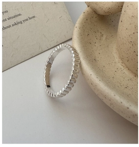 Macro detail of S925 sterling silver ring showing vertical texture and hallmark stamp