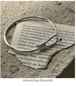 Macro detail of silver horseshoe shackle knot bracelet on vintage paper texture