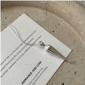 Close-up of S925 sterling silver matte teardrop pendant with textured ribbed details