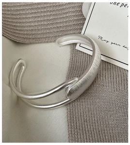 Detailed macro shot of an S925 sterling silver cuff featuring a unique brushed matte texture