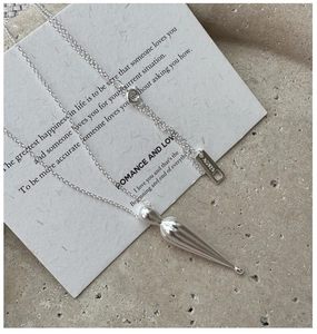 Macro detail of S925 sterling silver water drop pendant with AG925 hallmark engraving