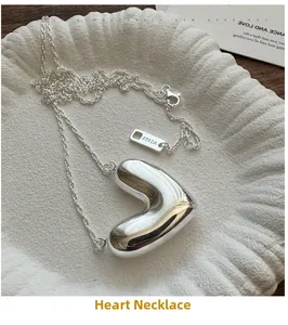 Macro shot of 3D hollow heart pendant necklace with Ag925 silver hallmark tag