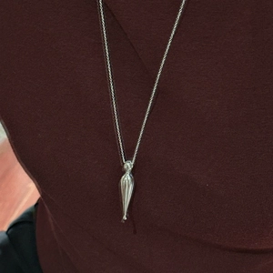 Minimalist S925 sterling silver drop necklace worn on a red knit sweater