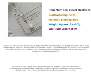 Detail of S925 sterling silver heart pendant with matte brushed finish on long necklace
