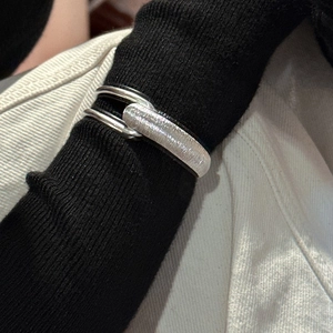 Minimalist S925 sterling silver cuff bracelet with brushed texture worn over a black sleeve