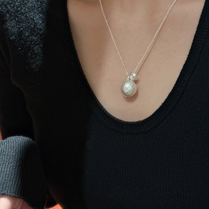 Minimalist S925 sterling silver ball necklace with hammered texture on a black background