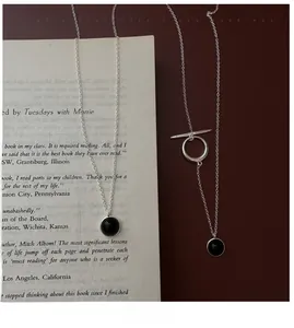 Detail of S925 silver necklace featuring black agate pendant and toggle clasp closure